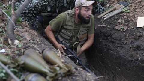 A Ukrainian soldier walks along a trench at a position along the front line in the Donetsk region on August 15, 2022. (Anatolii Stepanov/AFP via Getty Images)