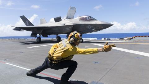 U.S. Navy Aviation Boatswain’s Mate (Handling) 3rd Class Nicolas Fareri launches a U.S. Marine Corps F-35B Lightning II aircraft with Marine Fighter Attack Squadron 121 off the amphibious assault carrier USS Tripoli (LHA 7) during Valiant Shield 2022 (VS22), June 13, 2022. Exercises such as Valiant Shield allows the Indo-Pacific Command Joint Task Force the opportunity to integrate forces from all branches of service to conduct long-range, precise, lethal, and overwhelming multi-axis, multi-domain effects t