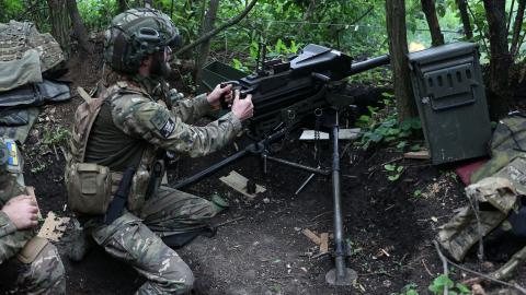 A Ukrainian soldier of the 28th Separate Mechanized Brigade fires a 40mm grenade launcher at the front line near Bakhmut, Ukraine, on June 17, 2023. (Photo by Anatolii Stepanov/AFP via Getty Images)