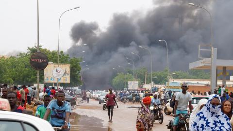 Smoke rises after coup supporters set fire to the headquarters of President Mohamed Bazoum's party, the Party for Democracy and Socialism in Niger (PNDS-TARAYA) in Niamey, Niger on July 27, 2023. (Photo by Balima Boureima/Anadolu Agency via Getty Images)