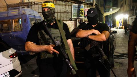 Palestinian gunmen from the Fatah movement carry their weapons in support of the Palestinian Authority headed by President Mahmoud Abbas during a military parade in the Askar refugee camp in the West Bank city of Nablus. (Nasser Ishtayeh/SOPA Images/LightRocket via Getty Images)