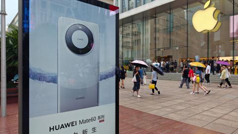 A light box advertising Huawei Mate 60 mobile phone is seen in front of the Apple store on Nanjing Road in Shanghai, China, on September 13, 2023. (CFOTO/Future Publishing via Getty Images)