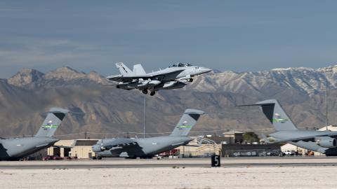 A Navy EA-18G aircraft takes off during a US Air Force Weapons School Integration (WSINT) exercise at Nellis Air Force Base on November 21, 2022. (US Air Force photo by William R. Lewis)