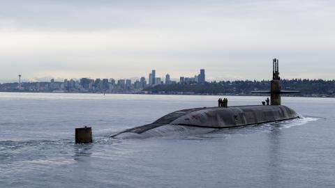 The Ohio-class ballistic missile submarine USS Louisiana (SSBN 743) transits Puget Sound past the Seattle skyline on February 9, 2023. (US Navy photo by Mass Communication Specialist Brian G. Reynolds)