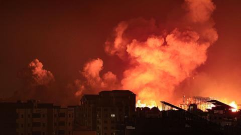 A fireball erupts during Israeli bombardment of Gaza City on October 9, 2023. (Mahmud Hams/AFP via Getty Images)