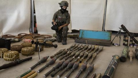  An Israeli soldier displays military equipment and ammunition that Hamas and Palestinans militants used at the time of the attack on the Israeli south border with the Gaza Strip on October 20, 2023 in Kiryat Malakhi, Israel. As Israel prepares to invade the Gaza Strip in its campaign to vanquish Hamas, the Palestinian militant group that launched a deadly attack in southern Israel on October 7th, worries are growing of a wider war with multiple fronts, including at the country's northern border with Lebano