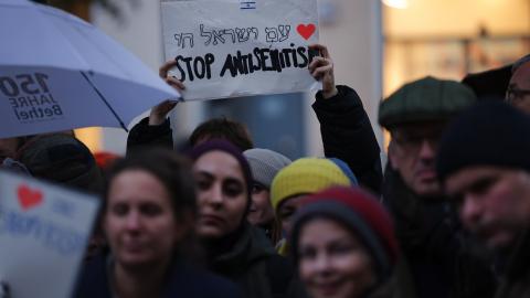 A participant holds a sign that reads "Stop Antisemitism" during a vigil outside the community center and synagogue of the Kahal Adass Jisroel Orthodox Jewish community on October 20, 2023, in Berlin, Germany. (Sean Gallup via Getty Images)