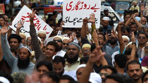 A trader holds a placard reading "prevent unemployment from rising" during a protest in Karachi, Pakistan, on August 23, 2023. (Asif Hassan/AFP via Getty Images)