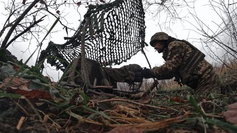 A Ukrainian military man shoots from a trophy AGS-17 on October 27, 2023 in the Bakhmut district of Ukraine. Ukrainian forces continue to fight to retake Bakhmut, which was captured by Russian forces in May, following a yearlong battle. Over the summer, Ukraine regained territory north and south of Bakhmut but Russia has held the city itself. (Photo by Kostya Liberov / Libkos via Getty Images)