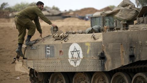 Israeli combat engineers maneuver their armored vehicles at a staging point near the Israeli border on November 14, 2023, near Sderot, Israel. (Christopher Furlong via Getty Images)