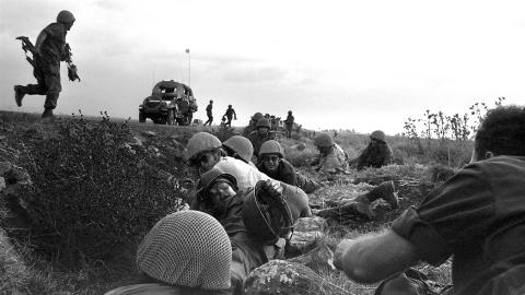 Israeli soldiers and journalists take cover from Syrian planes strafing the road on the Golan Heights during the 1973 Arab-Israeli War on October 8, 1973. (Ze'ev Spector/GPO/AFP via Getty Images)