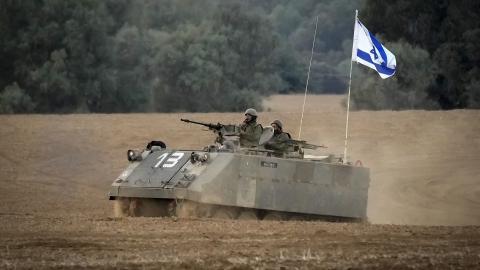 An Israeli armoured personnel carrier patrols near the border with Gaza on November 14, 2023, in Southern Israel. (Christopher Furlong via Getty Images)