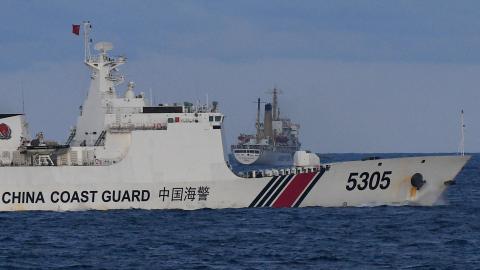 A Chinese Coast Guard ship sails near a Philippine vessel that was part of a convoy of civilian boats in the disputed South China Sea on December 10, 2023. (Photo by Ted Aljibe via Getty Images)