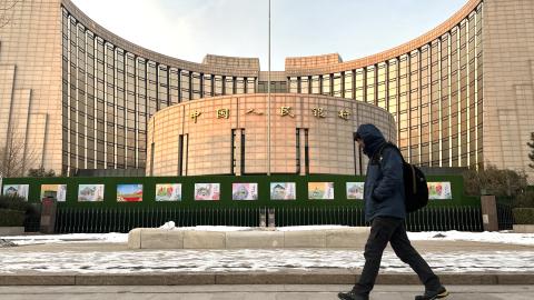 A man walks past the People's Bank of China building on December 25, 2023, in Beijing, China. (Jiang Qiming/China News Service/VCG via Getty Images)