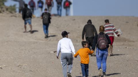 Immigrants from Venezuela walk toward a US Border Patrol transit center after crossing the Rio Grande into the United States on January 8, 2024, in Eagle Pass, Texas. (John Moore via Getty Images)