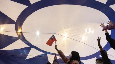 Supporters cheer under a huge flag of Taiwan during an election campaign rally of Kuomintang (KMT) presidential candidate Hou Yu-ih in New Taipei City on January 12, 2024. (Photo by ALASTAIR PIKE / AFP) (Photo by ALASTAIR PIKE/AFP via Getty Images)