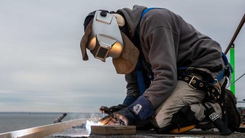A contractor welds on the flight deck aboard the aircraft carrier USS John C. Stennis (CVN 74), in Norfolk, Virginia, on January 21, 2014. (US Navy photo by Mass Communication Specialist Seaman Crayton Agnew)