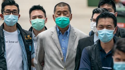Hong Kong media tycoon and Apple Daily founder Jimmy Lai is escorted by the police to the Royal Hong Kong Yacht Club Shelter Cove Clubhouse for evidence collection as part of the ongoing investigations on August 11, 2020, in Hong Kong, China. (Anthony Kwan via Getty Images)