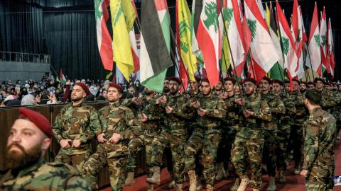 Pro-Iranian Hezbollah militants march with Lebanese, Palestinian, and Hezbollah flags during a mass rally to mark al-Quds Day (Jerusalem Day). (Marwan Naamani/picture alliance via Getty Images)