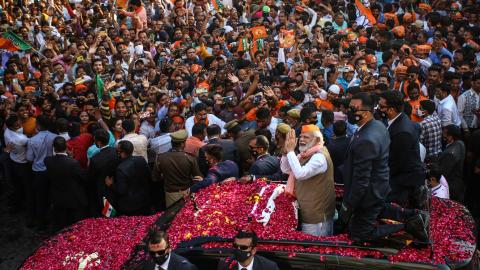 Indian Prime Minister Narendra Modi greets crowds of supporters during a roadshow in support of state elections on March 4, 2022, in Varanasi, India. (Ritesh Shukla via Getty Images)