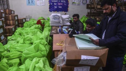 Pakistan election commission workers prepare election materials at a distribution center in Karachi on February 6, 2024. (Asif Hassan/AFP via Getty Images)