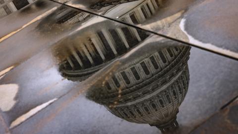 The US Capitol building is seen reflected in rain puddles on February 11, 2024, in Washington, DC. (Samuel Corum via Getty Images)