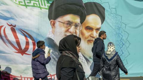 Iranians attend an annual rally commemorating the 1979 Islamic Revolution with portraits of Iranian Leaders in the background on February 11, 2024, in Tehran, Iran. (Photo by Majid Saeedi/Getty Images)