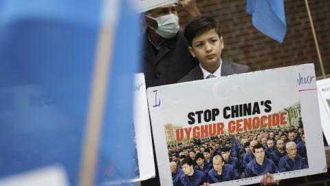 A boy protests China's genocide against the Uyghurs at a demonstration in Washington, DC, on April 16, 2021. (Photo by Drew Angerer/Getty Images)