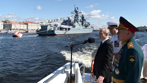 Russian President Vladimir Putin, accompanied by Defence Minister Sergei Shoigu and Commander-in-Chief of the Russian Navy, Admiral Nikolai Yevmenov, attending the Navy Day parade in Saint Petersburg on July 30, 2023. (Alexander Kazakov via Getty Images)