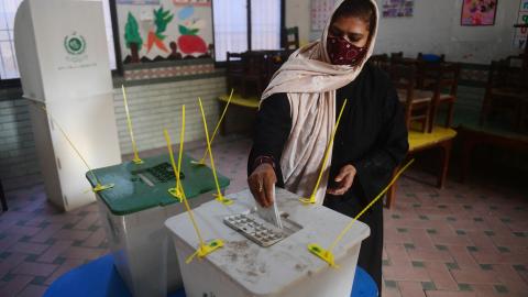 A woman casts her ballot to vote at a polling station during Pakistan's national elections in Karachi on February 8, 2024. (Photo by Asif Hassan/AFP via Getty Images)