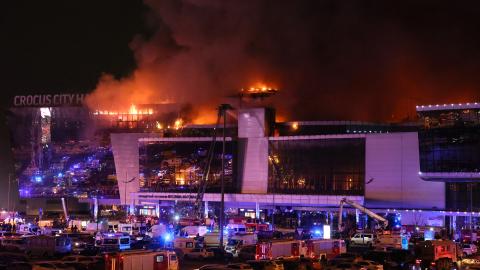 Emergency services vehicles are seen outside the burning Crocus City Hall in Krasnogorsk, Russia, on March 22, 2024. (Stringer via Getty Images)