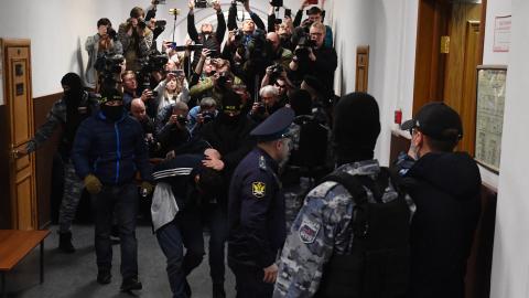 A man suspected of taking part in the attack of a concert hall that killed 137 peopleis escorted by Russian law enforcement officers at the Basmanny District Court in Moscow on March 24, 2024. (Photo by Olga MALTSEVA / AFP) (Photo by OLGA MALTSEVA/AFP via Getty Images)