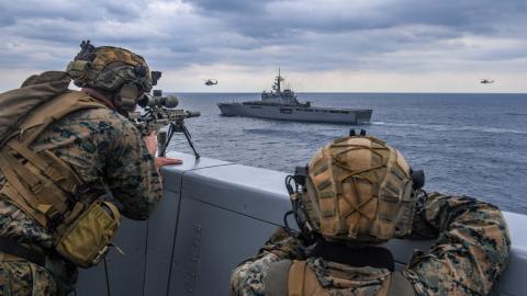Sailors on the USS Green Bay participate in a visit, board, search and seizure (VBSS) drill with JS Osumi of the Japan Maritime Self-Defense Force (JMSDF) as part of Exercise Iron Fist near Japan on March 4, 2023. (US Navy photo by Mass Communication Specialist 2nd Class Matthew Cavenaile)