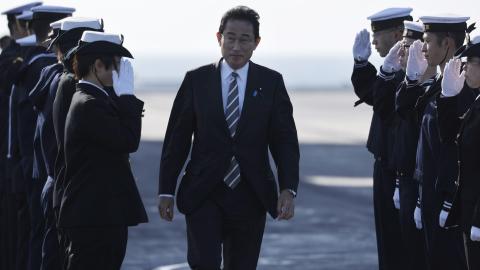 Japanese Prime Minister Fumio Kishida is saluted by members of the Japan Maritime Self-Defence Force during an International Fleet Review on November 6, 2022, off Yokosuka, Japan. (Photo by Issei Kato/Pool/Getty Images)