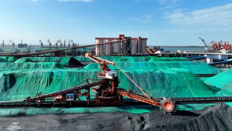 Machines load and unload coal at Lianyungang Port in Lianyungang City, China, on May 24, 2023. (Costfoto/NurPhoto via Getty Images)