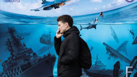 People walk past a poster depicting Russian warships sunk by Ukrainian attacks in the Black Sea on March 16, 2024, in Kyiv, Ukraine. (Photo by Oleksii Chumachenko/Global Images Ukraine via Getty Images)