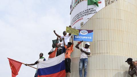 Protestors hold Russian and Chinese flags in Niamey, Niger, on August 20, 2023. (Photo by AFP via Getty Images)