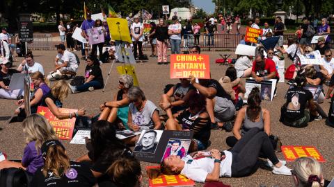 Demonstrators sit during a moment of silence at a rally against fentanyl near the White House in Washington, DC, on September 17, 2022. (Eric Lee for The Washington Post via Getty Images)
