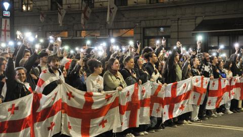  Demonstrators hold a Georgian flag during a protest against the “foreign agents” bill after the Georgian Parliament voted through the law on May 15, 2024, in Tbilisi, Georgia.