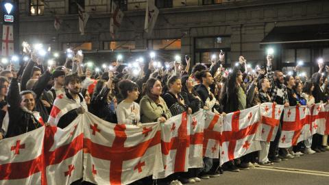 Demonstrators hold a Georgian flag during a protest against the “foreign agents” bill after the Georgian Parliament voted through the law on May 15, 2024, in Tbilisi, Georgia.