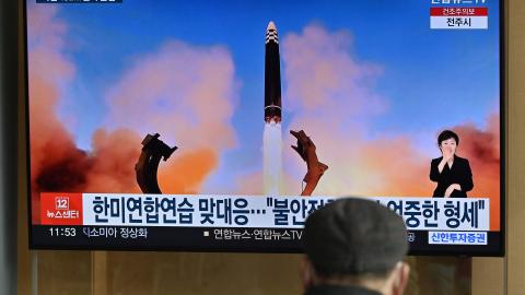 A television news screen in Seoul, South Korea, on March 17, 2023, shows a picture of North Korea's test-firing of a Hwasong-17 intercontinental ballistic missile. (Jung Yeon-je/AFP via Getty Images)