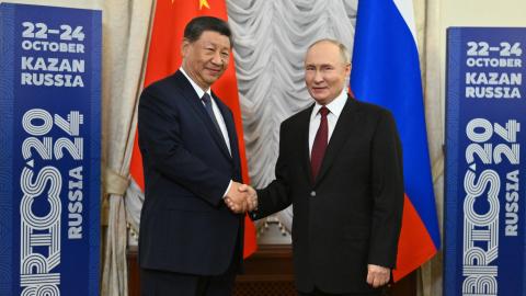Vladimir Putin and Xi Jinping shake hands at the BRICS Summit in Kazan, Russia, on October 22, 2024. (Kristina Kormilitsyna/Anadolu via Getty Images)