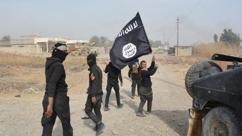 Iraqi government forces celebrate while holding an Islamis Sate (IS) group flag after they claimed they have gained complete control of the Diyala province, northeast of Baghdad, on January 26, 2015 near the town of Muqdadiyah. Iraqi forces have "liberated" Diyala province from the Islamic State jihadist group, retaking all populated areas of the eastern region, a top army officer said today. The symbolic victory for Baghdad, which has at times struggled to push IS back, could clear the way for further adva