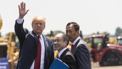 U.S. President Donald Trump (L) waves as Foxconn CEO Terry Gou (R) and Masayoshi Son, chairman and CEO of SoftBank Group watch at the groundbreaking for the Foxconn Technology Group computer screen plant on June 28, 2018 in Mt Pleasant, Wisconsin. Foxconn has committed to build a $10 billion plant in what it has named the Wisconn Valley Science and Technology Park, and to creating 13,000 Wisconsin jobs. (Photo by Andy Manis/Getty Images)