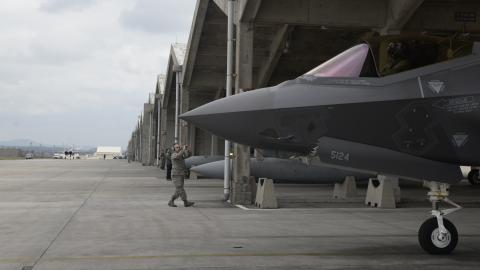 US Air Force Airman 1st Class Austin House, 388th Aircraft Maintenance Squadron crew chief, marshals an F-35A Lightning II from underneath a hardened facility on January 24, 2018, at Kadena Air Base, Japan. (US Air Force)