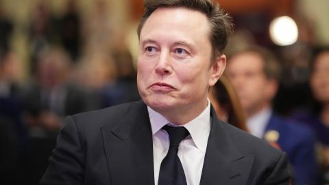 Elon Musk listens as President-elect Donald Trump addresses a House Republicans Conference meeting on November 13, 2024, in Washington, DC. (Andrew Harnik via Getty Images)