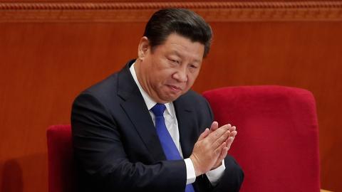 Chinese President Xi Jinping applauds during the opening of the National People's Congress on March 5, 2015, in Beijing, China. (Lintao Zhang via Getty Images).