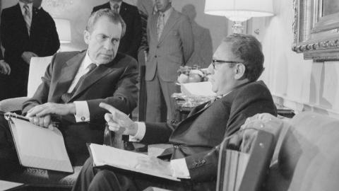 Presidential advisor Henry A. Kissinger gestures as he talks with President Nixon late November 25th at New York's Waldorf Astoria Hotel. The President interrupted a vacation weekend in New York to talk with Kissinger whom he called home from Paris to consult on South Vietnamese objections which appear to have developed into a major road block to a Vietnam settlement.
