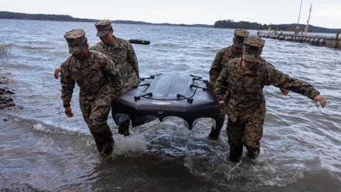 US marines carry a general purpose high speed uncrewed surface vehicle, known as the Reckless, during exercise Baltic Operations 24 at Camp Berga, Sweden, on June 12, 2024. (US Marine Corps photo)