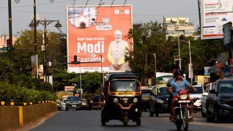 Commuters are passing by Prime Minister Narendra Modi's poster ahead of the Lok Sabha election in Mumbai, India, on April 17, 2024. (Indranil Aditya/NurPhoto via Getty Images)